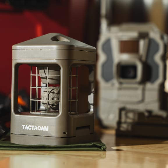 Tactacam REVEAL Wind Sensor next to a REVEAL trail camera